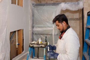 Plumber preparing a water pipe for installation. 