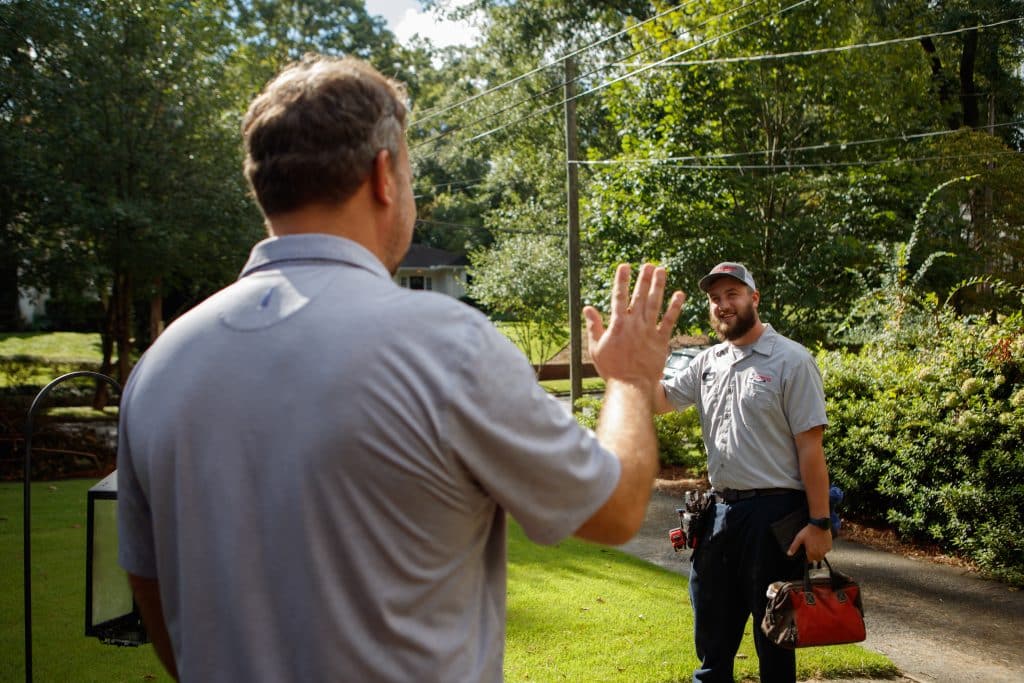 Plumbing Express technician with a happy Atlanta homeowner after a whole-home repipe